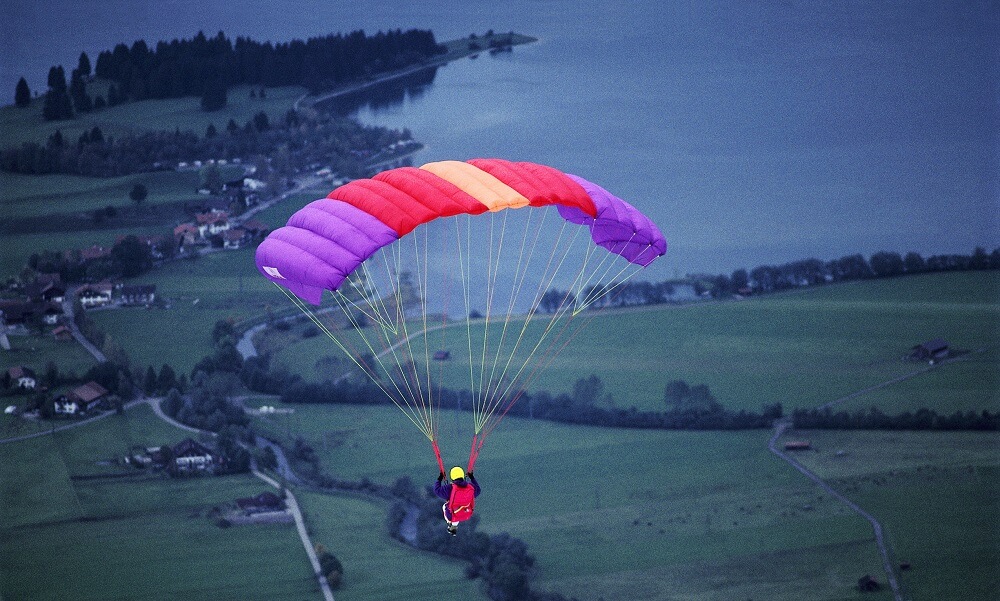Parachutist Flying Over Coastal Area