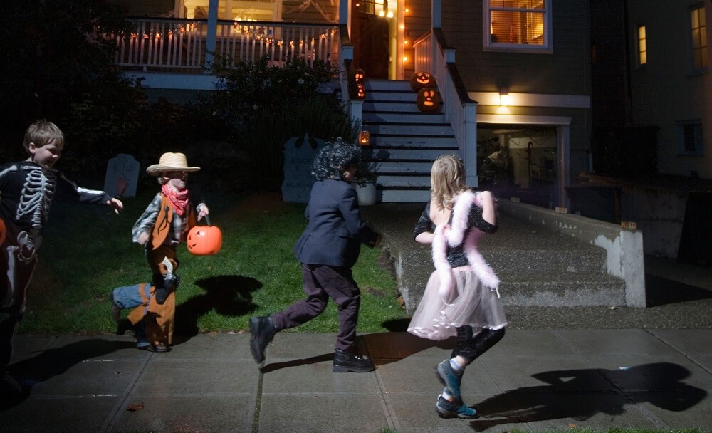 Young children trick or treating on Halloween