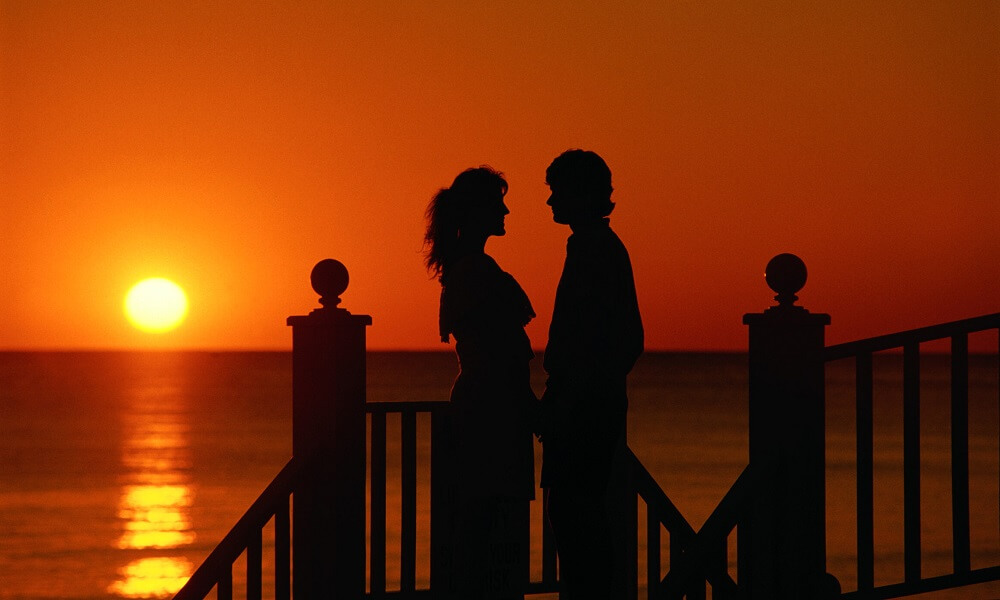 Silhouette of Couple at Sunset on Beach