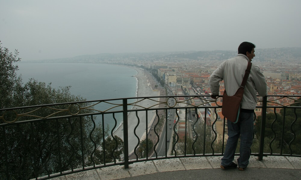 Man out walking overlooking the city of Nice, France