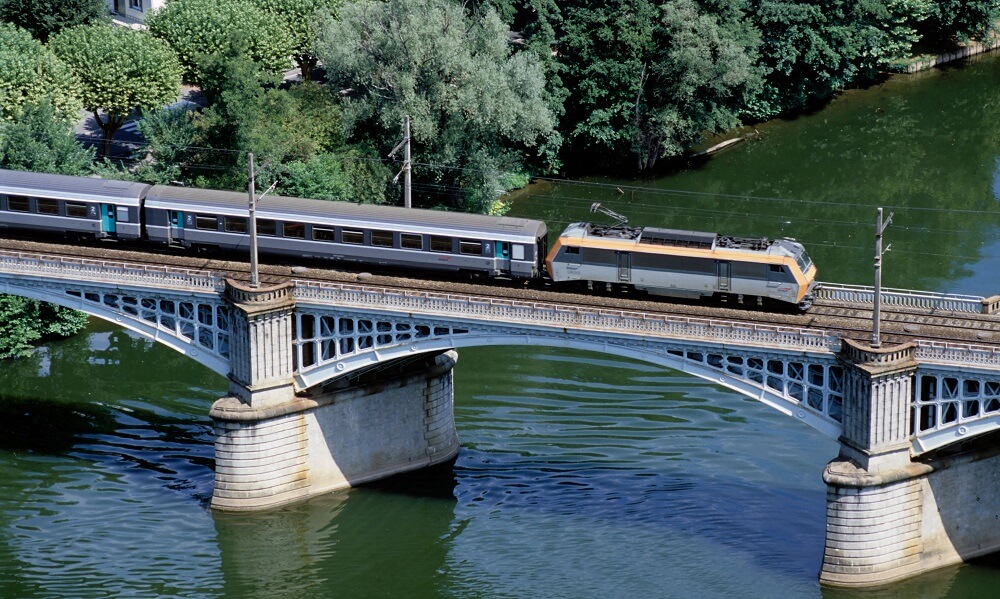 Train on a railway bridge over River Lot in Southern France