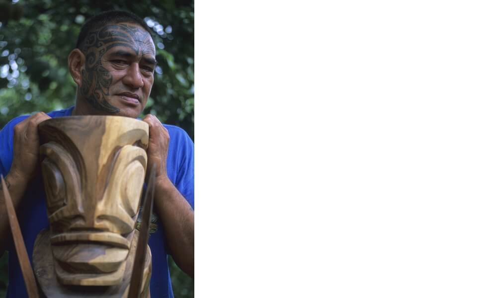 Man holding a sculpture in HivaOa, French Polynesia
