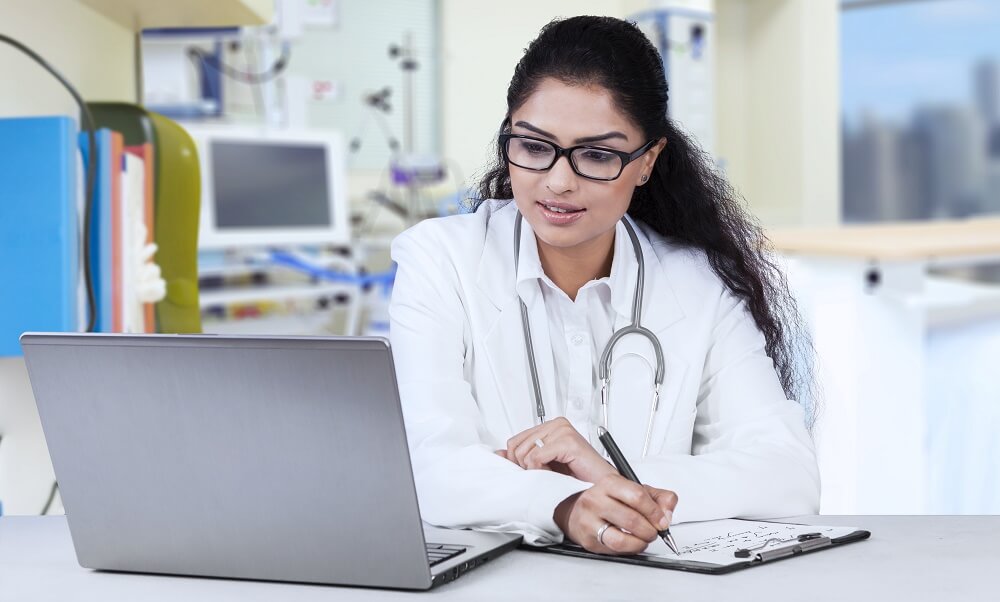 Doctor looking at laptop