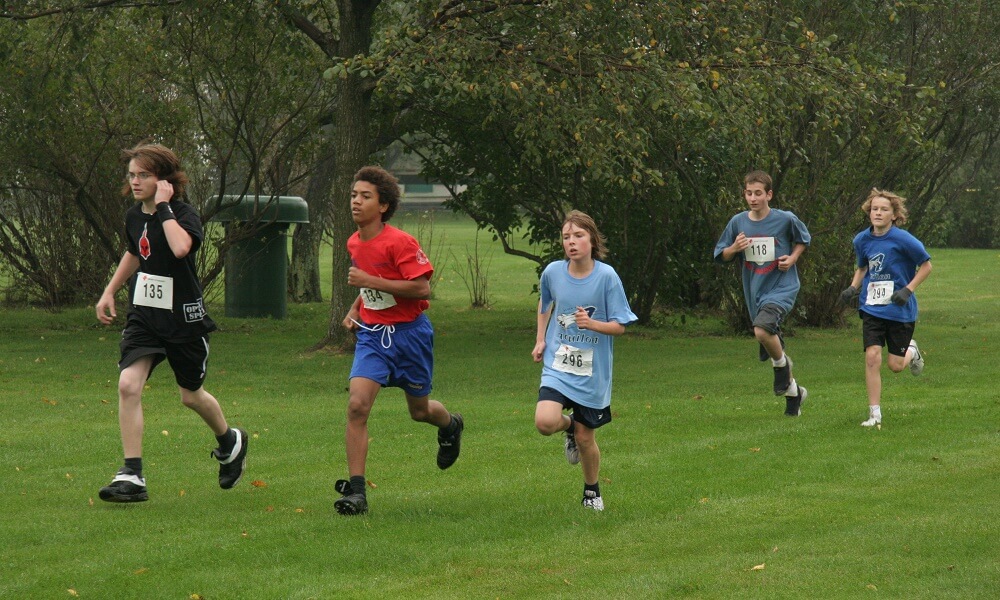 Teens running in a cross country race on the Plains of Abraham Park in Quebec City, Canada