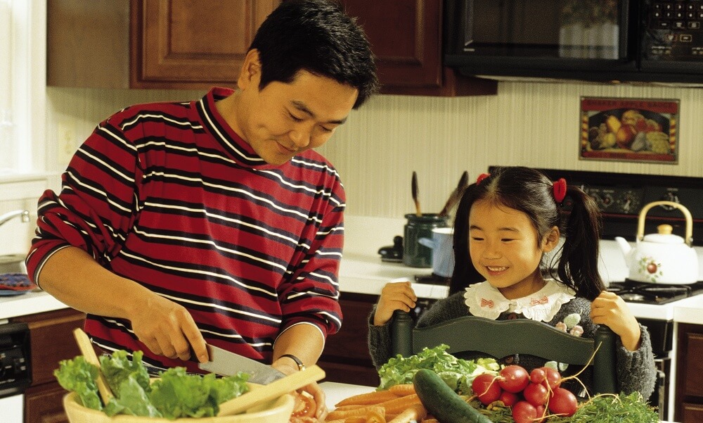 Father and daughter preparing meal