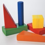 Colored wooden blocks in an assortment of shapes including triangles, cylinders, cubes, and rectangles