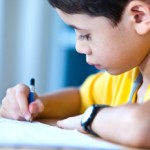 Young boy doing his homework in a home environmentTBC