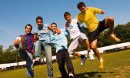 Group of teenage boys, friends on a soccer field