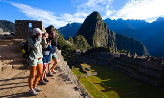 Students taking pictures of the ruins at Machu Picchu