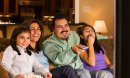 Hispanic family watching television together