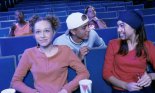 Teenage boys and girls watching a movie in a theater