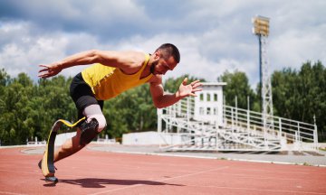 One-legged runner training on the sport track