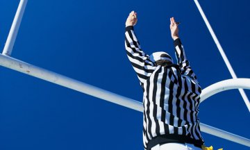 Referee giving signal for successful field goal