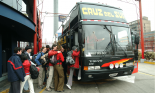 People getting on bus in Lima, Peru