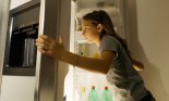 Girl looking into the refrigerator