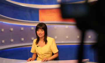 TV reporter presenting the news in studio