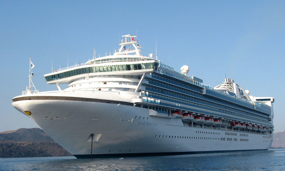 Star Princess cruise ship at anchor off tropical island
