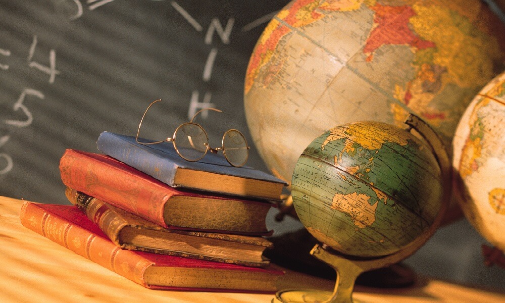 Books and globes on school desk