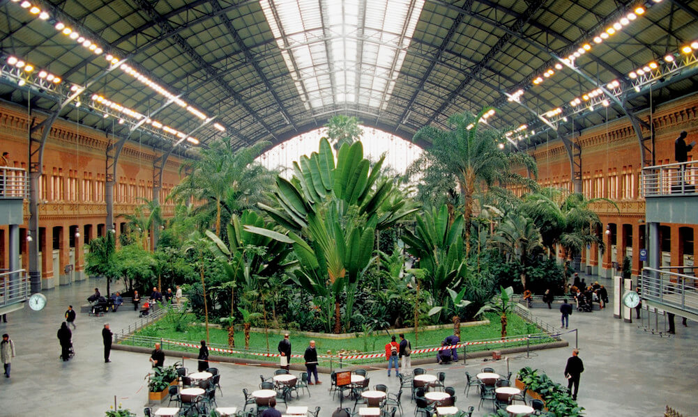 Caption: High angle view of commuters standing at Atocha Station, Madrid, Spain