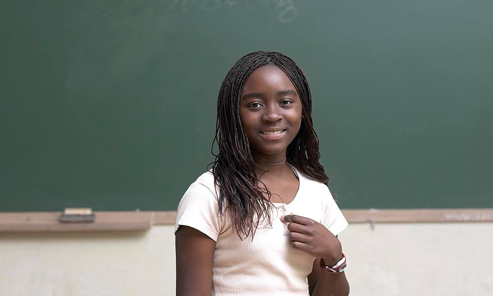 Girl in front of blackboard