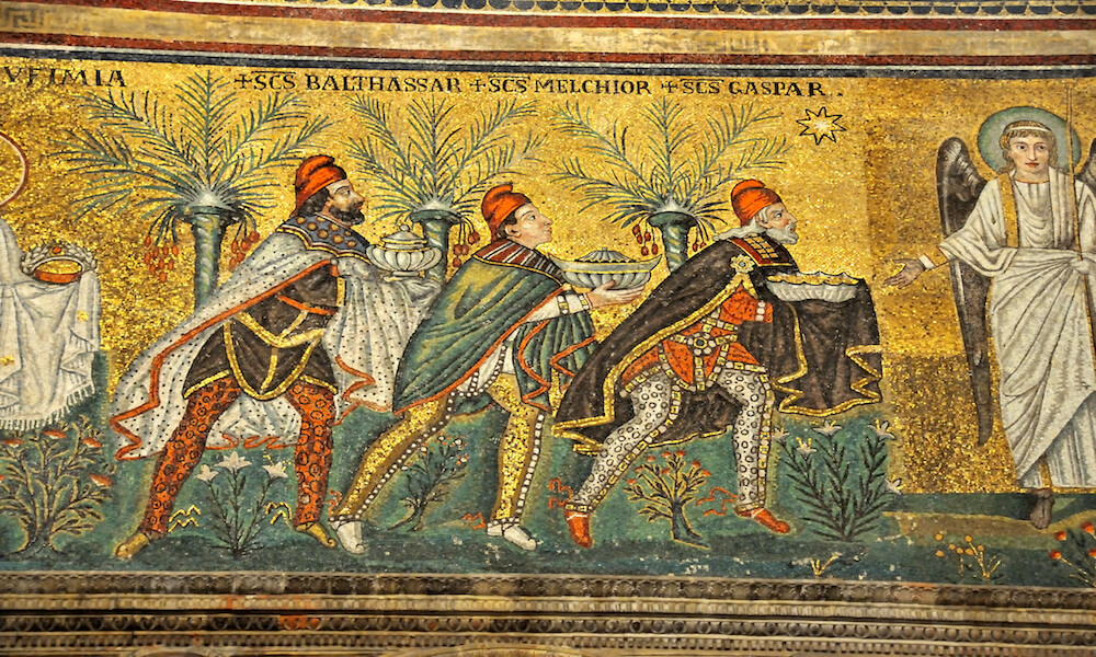 Mosaic scene from the nativity. Three kings arrive bearing gifts. An angel is there to receive them.