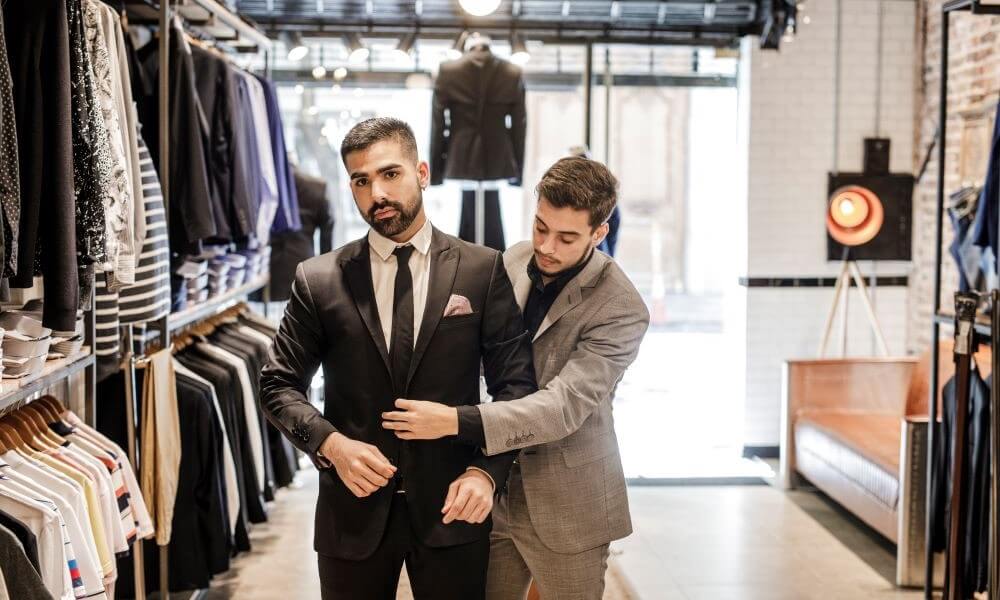 Young businessman trying on a new suit in a store