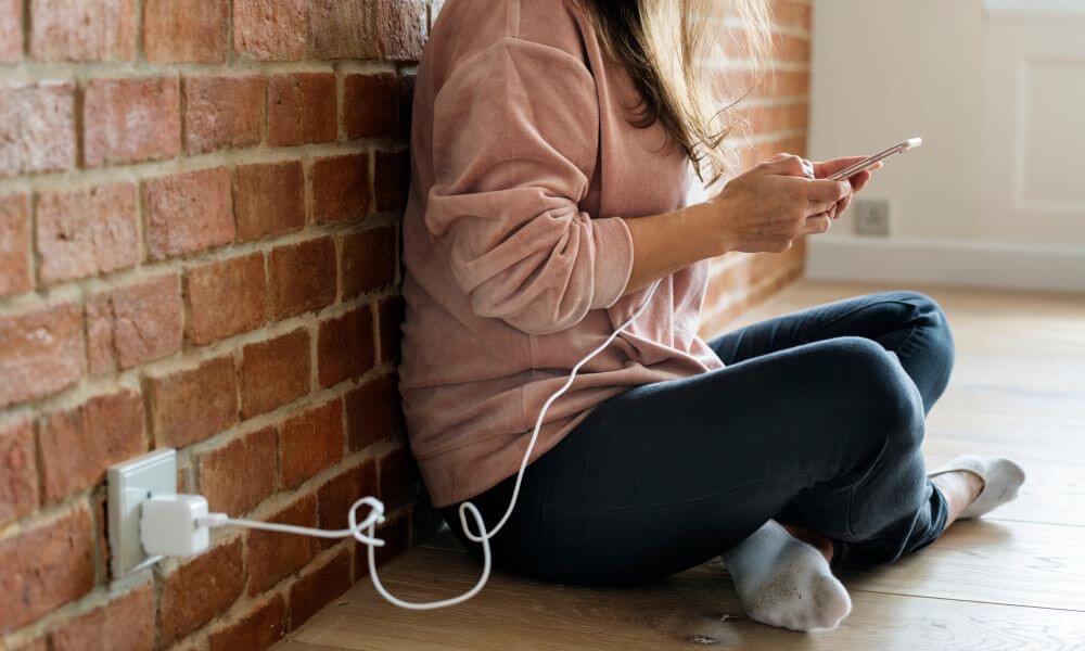 Woman using a Smartphone as it is being charged