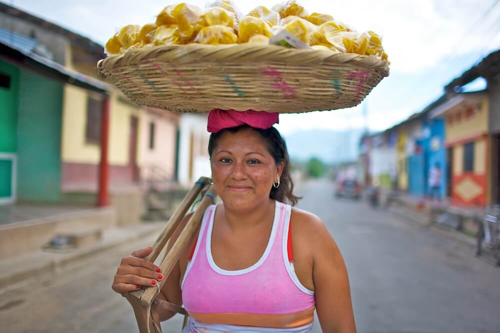 Woman balancing a basket of food on her head